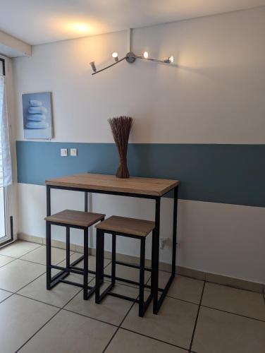 une table et deux tabourets dans une pièce dans l'établissement Gite MARTIN, à Grabels