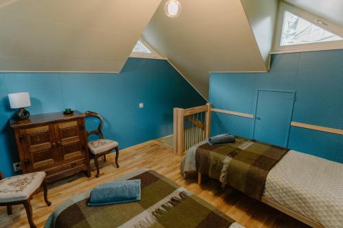a attic bedroom with two beds and a table and chairs at Rītu atpūtas namiņi in Talsi