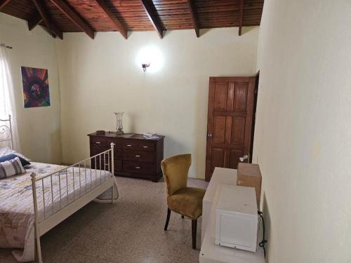 a bedroom with a bed and a desk and a table at Suite Georgiana - Ensuite Double Bedroom, Cardiff Hall, Runaway Bay, One Mile to Beaches, 1 Hour From Montego Bay Airport in Runaway Bay