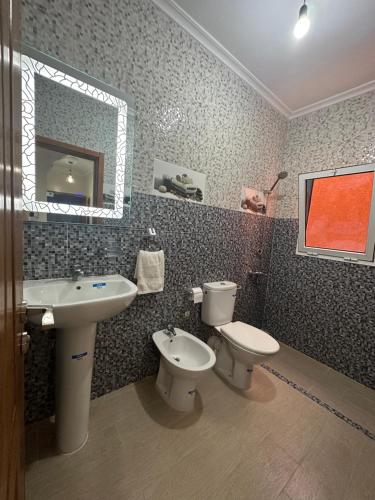a bathroom with two toilets and a sink and a mirror at Appartement à Houma, proche Port Tanger Med in Dalia