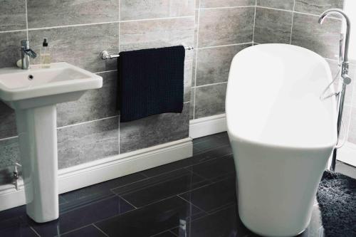 a bathroom with a sink and a white toilet at The Coffee House in Coleford