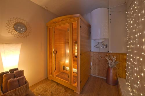 a large wooden cabinet in a room with a chair at Valley Vendégház in Eger