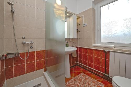 a bathroom with a shower and a sink and a toilet at Valley Vendégház in Eger