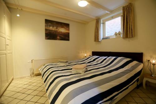 Ένα ή περισσότερα κρεβάτια σε δωμάτιο στο Bungalow Callantsoog