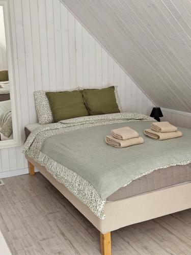 a bed with two pillows on it in a bedroom at Ubytovanie Hronec in Hronec