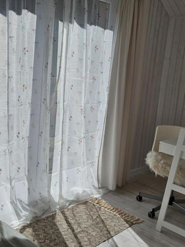 a bedroom with a bed with a white curtain at Ubytovanie Hronec in Hronec