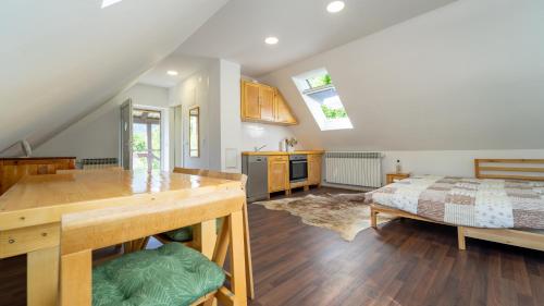 a kitchen and living room with a bed in a room at Apartman pri Kupi in Kuželj