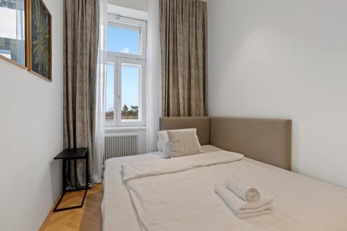 a bedroom with a large bed with a window at sgrafit apartments - Self Check-In in Retz
