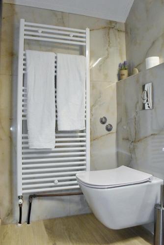a bathroom with a tub and a toilet and a shower at Dreamy Loft apartment Lixouri in Lixouri