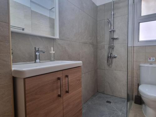 a bathroom with a sink and a toilet at Cassia Seaview Retreat in Chlorakas