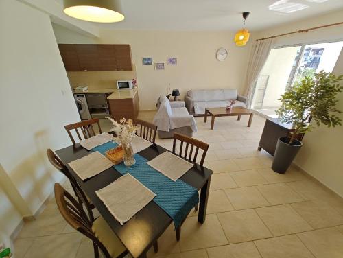 a dining room with a table and a living room at Cassia Seaview Retreat in Chlorakas