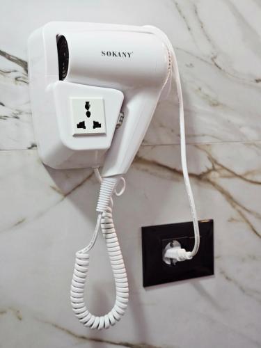 a white phone is hanging on a wall at Hani i Ilirit in Cërrik