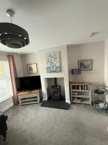 a living room with a flat screen tv at The Clara, Ballycastle in Ballycastle