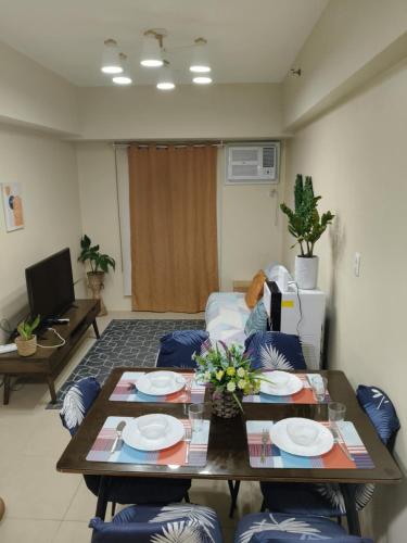 a living room with a table and a couch at Kler Condo Garden with City View in Tabok