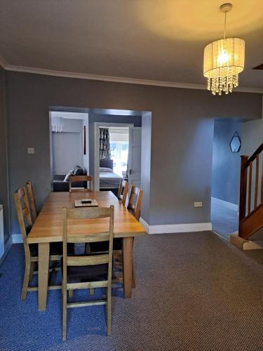 a dining room with a wooden table and chairs at 94 Main Street - Pembroke Holiday Home in Pembroke
