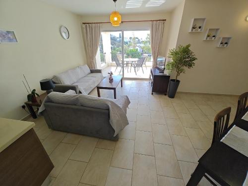 a living room with a couch and a table at Cassia Seaview Retreat in Chlorakas