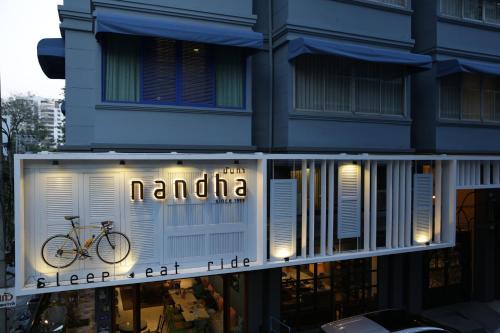 a bike parked in front of a building at Nandha Hotel in Bangkok