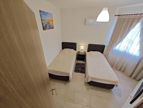 a hospital room with two beds and a window at Cassia Seaview Retreat in Chlorakas