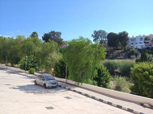 a small car parked in a parking lot at Cassia Seaview Retreat in Chlorakas