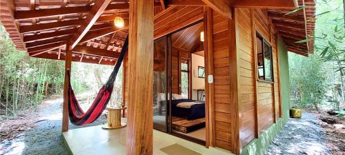 a tree house with a hammock in the woods at Cabana de madeira entre as árvores in Piedade