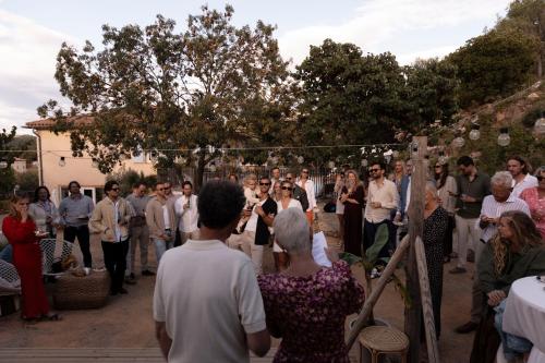 a group of people walking down the aisle at a wedding at NOUS in Agel