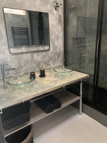 La salle de bains est pourvue d'une douche et de 2 lavabos en verre. dans l'établissement Loft vue Bassin Arcachon Marina de Cassy, à Lanton