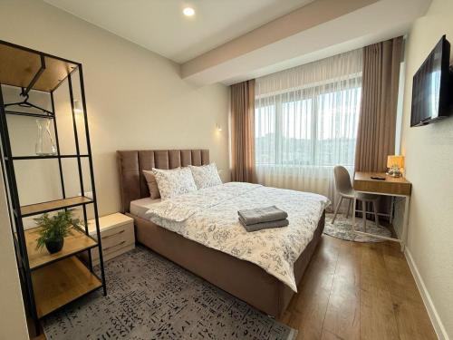 a small bedroom with a bed and a window at RentNow Large and Cozy Apartment in the Center, Parking in Chişinău