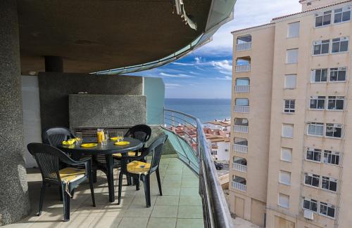 a balcony with a table and chairs and a view of the ocean at Costa Azul 5 L in La Manga del Mar Menor