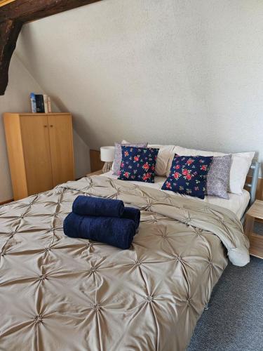 a large bed with two blue pillows on top of it at Wohnung mit Privtbad in Gaggenau