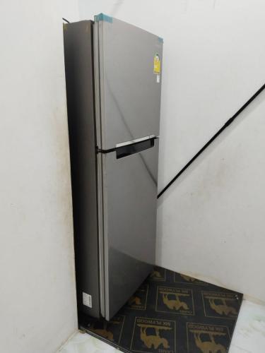 a stainless steel refrigerator in a corner of a room at Lavendrata I in Phnom Penh