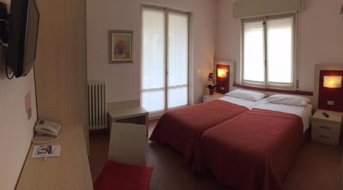Postel nebo postele na pokoji v ubytování Albergo Riva