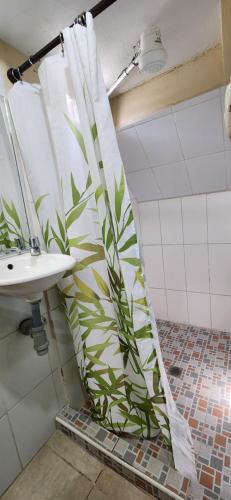 a bathroom with a shower curtain next to a sink at Casa Altamira in San Pedro Sula