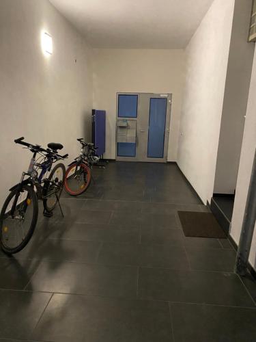 two bikes are parked in a room with a hallway at Moderne Wohnung Kerpen in Kerpen