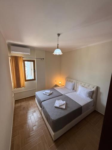 a bedroom with a bed with two towels on it at Hotel Milo Ksamil in Ksamil
