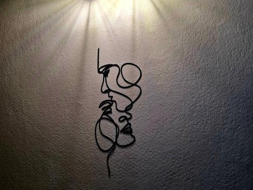 a drawing of a pair of scissors on a wall at Mansarda in Osijek