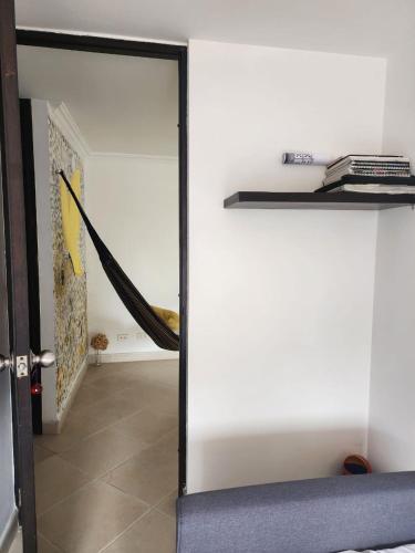 a sliding glass door in a room with a hallway at Habitación con sofacama - apto compartido in Envigado