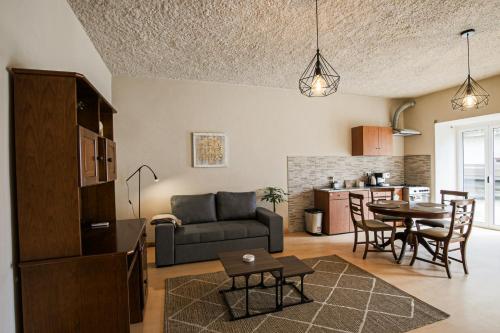 a living room and kitchen with a couch and a table at Casa Pinheiro in Pinheiro de Coja