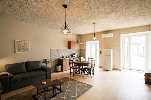 a living room with a couch and a table at Casa Pinheiro in Pinheiro de Coja