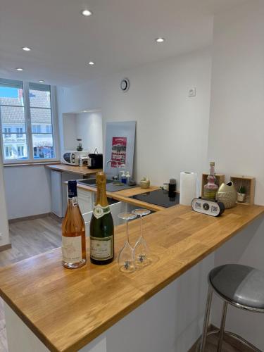 - deux bouteilles de vin assises sur un comptoir de cuisine dans l'établissement Appartement en champagne, à Dormans