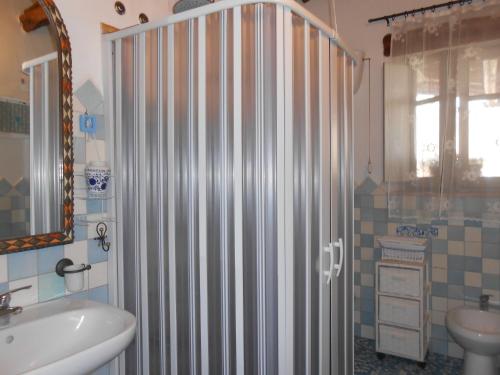 a bathroom with a shower curtain and a sink at Camere DomusAntiga wifi in San Giovanni Suèrgiu