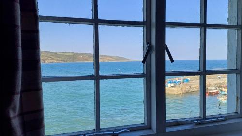 a view of the ocean from a window at The Old Post Office in Coverack