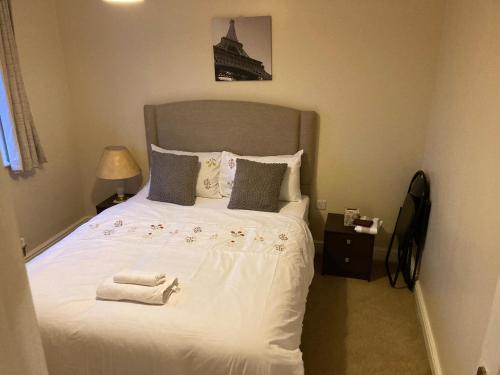 a bedroom with a large white bed with towels on it at InMind in Peterborough