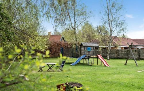 a yard with a playground with slides and a table at 3 Bedroom Cozy Home In Rørvig in Rørvig