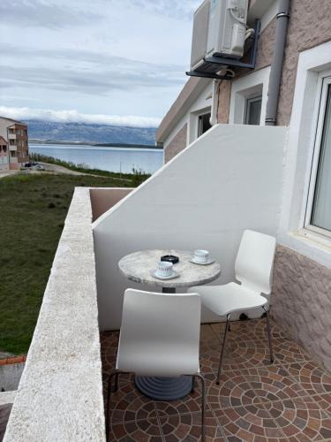 a patio with a table and two chairs on a balcony at Vila Kula in Nin