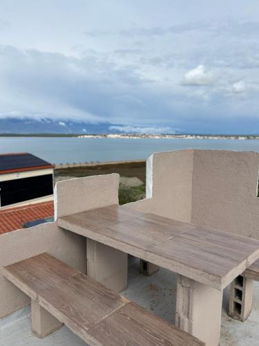 a wooden bench sitting on top of a table at Vila Kula in Nin