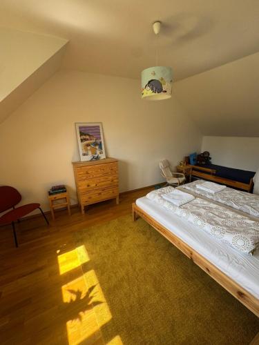 a bedroom with a bed and a wooden dresser at Chalupa - Vinařství Popela in Perná