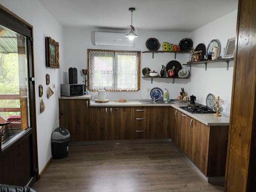 a kitchen with wooden cabinets and a counter top at Cabana de lemn Lacul Bicaz in Hangul
