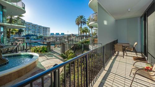 a balcony with a hot tub and a view of the beach at Lighthouse on the Bay 2109 condo in Orange Beach