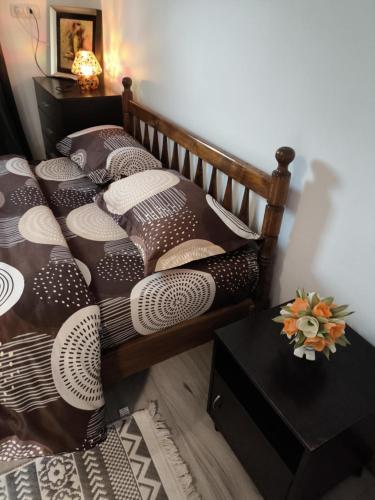 a bedroom with two beds with pillows and a table at Cabana de lemn Lacul Bicaz in Hangul