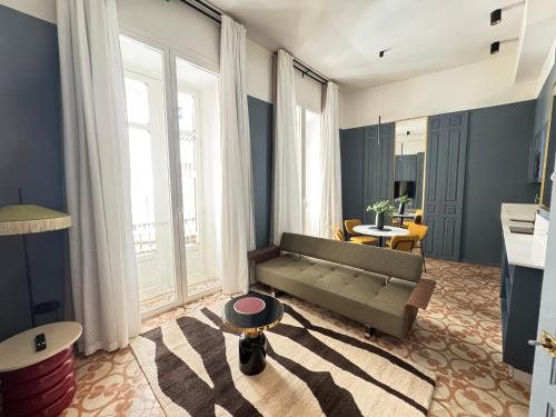 a living room with a couch and a table at Marino Marina - Unique & Exclusive Stay - Prime Location in Málaga
